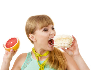 Woman choosing fruit or cake make dietary choice