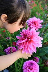 Little girl enjoy with the flowers