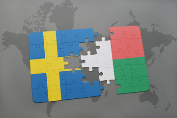 puzzle with the national flag of sweden and madagascar on a world map background.