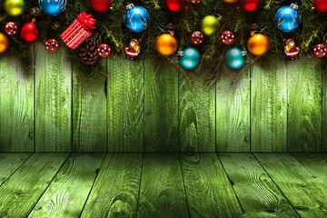 2017 Happy New Year seasonal background with real wood green pine, colorful Christmas baubles, gift boxe and other seasonal stuff over an old wooden aged background