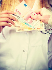 Fototapeta premium Female doctor bandaging male hand.