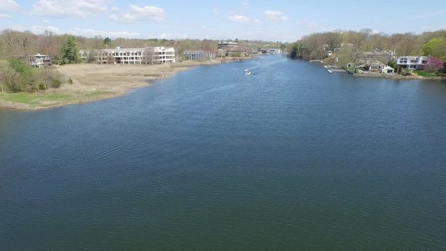 Aerial over river while teams of rowers practice, Saugatuck River.