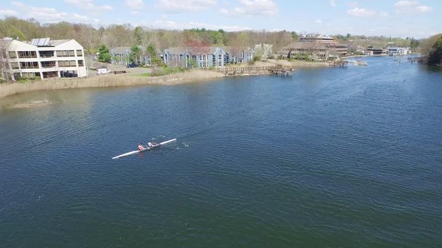 Aerial over river following tandem rowers, Saugatuck River.