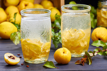 carbonated drink with syrup of japanese quince on fresh  fruits background