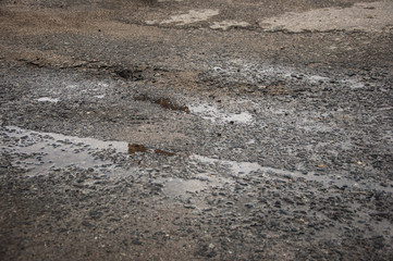 Bad road with holes in the asphalt