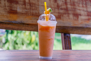 Melon smoothie on wooden table