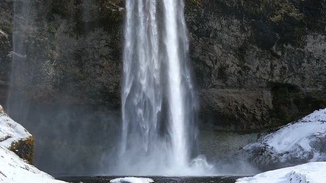 Slowmotion Seljalandsfoss waterfall tilt shot
