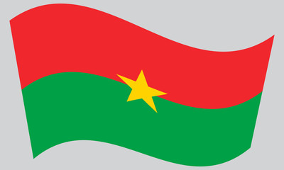 Flag of Burkina Faso waving on gray background