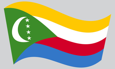 Flag of Comoros waving on gray background