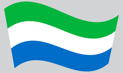 Flag of Sierra Leone waving on gray background