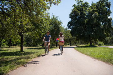 Obraz premium Young multiethnic couple having a bike ride in nature