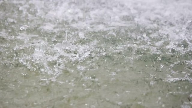 Heavy rain on water shooting high speed camera