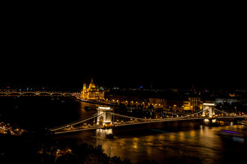 Fototapeta na wymiar Chain Bridge over the Danube with Hungrian Parliament in background illuminated at night, Budapest, Hungary – 23 Sep 2016
