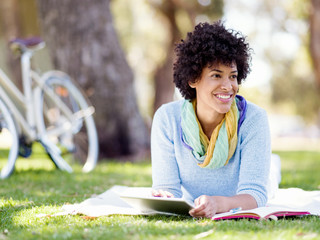 Young woman using tablet in the park.