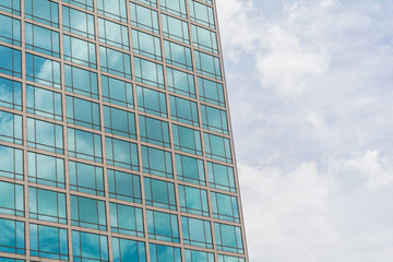 Building glass window pattern with a reflection of blue sky.