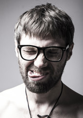 Obraz premium bearded man in glasses plays the fool. crazy man, funny expression