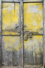 Yellow tarnished wood door, Jaisalmer, Rajasthan, India