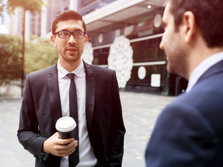 Two businessmen talking outdoors