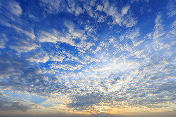 Fototapeta premium Beautiful yellow blue sunset sky with sunlight and cloud