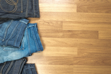 Blue jeans on a brown wooden background and Blue jeans denim Col