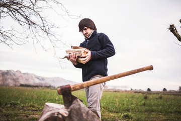 man chopping wood with an ax