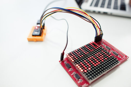 LED matrix display with words hello world. Electronic components for construction on white background, close-up. Technology, hobby, invention concept