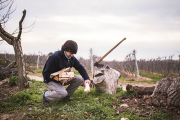 man chopping wood with an ax