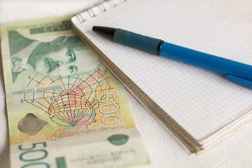 Serbian paper money, note pad and pen