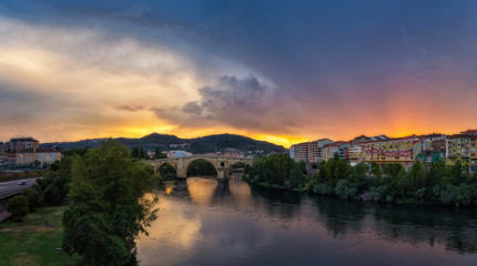 Fototapeta premium Sunset on a stormy day on the city of Ourense 