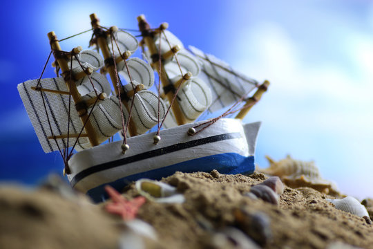 sand shell and sail in sea