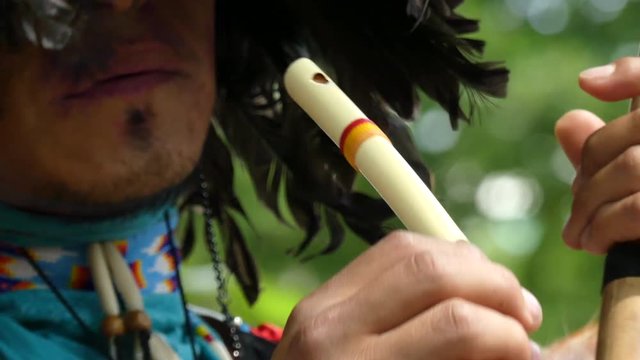 Male playing flute outdoor