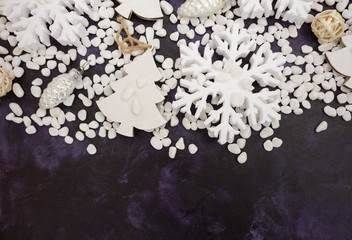 Christmas or New Year background: snowflakes, gifts, glass balls, decoration and cones on dark background