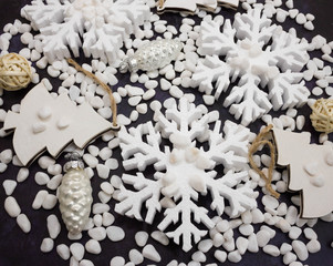 Christmas or New Year background: snowflakes, gifts, glass balls, decoration and cones on dark background