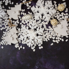 Christmas or New Year background: snowflakes, gifts, glass balls, decoration and cones on dark background