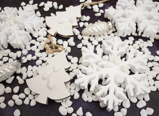 Christmas or New Year background: snowflakes, gifts, glass balls, decoration and cones on dark background