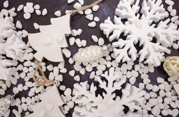 Christmas or New Year background: snowflakes, gifts, glass balls, decoration and cones on dark background