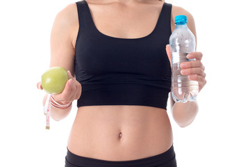 close-up of sporty girl who shows her an apple in one hand