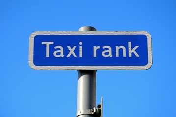 Taxi rank sign against a blue sky.