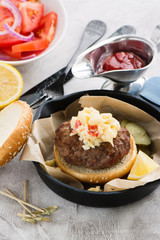 Homemade burger with spicy scrambled eggs and vegetables
