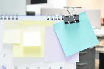Selective focus of paper notes on calendar at business office with copy space for text .