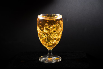 water with glass at black background