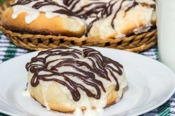 Homemade cinnabons cinnamon buns with cream cheese glaze and chocolate icing