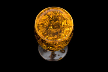 water with glass at black background