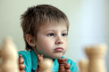 Portrait of a boy playing chess