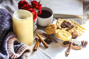 Warm and cozy,  concept.Still life a candle  tea .