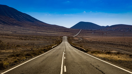 empty mountain road, twisting through the landscape
