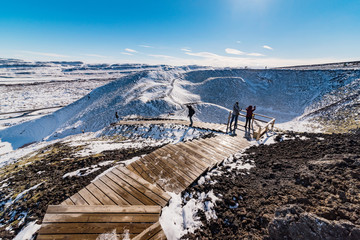 panoramic view from the volcano grabrok at wintertime with group of tourists © Marc Jedamus