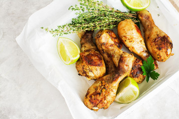 BBQ chicken drumsticks on wooden tray