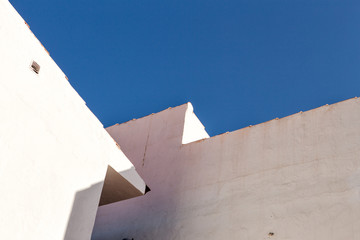 white stucco wall and a blue sky