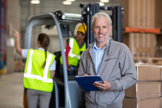 Portrait of warehouse manager holding a clipboard